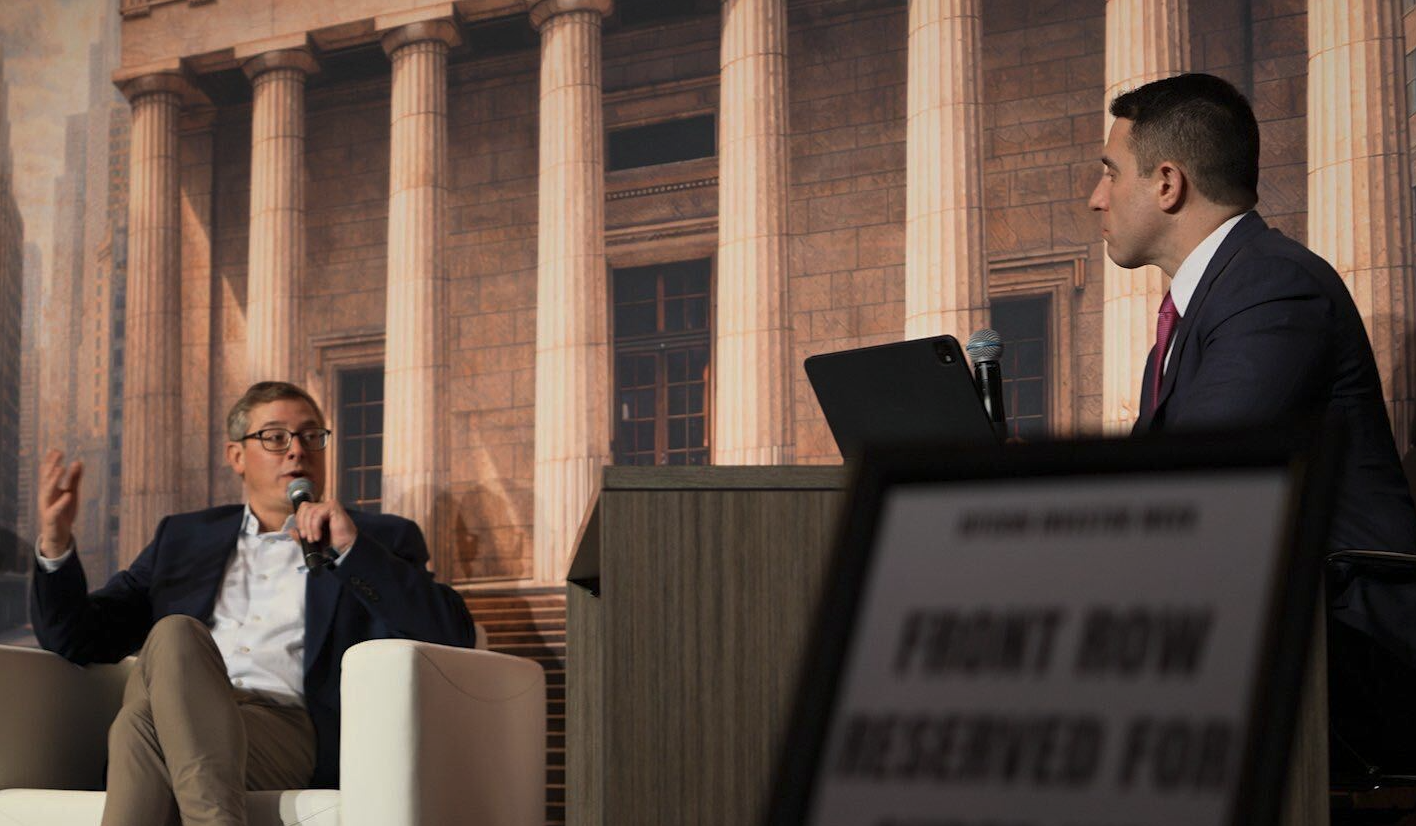 Chris Kline (left) on stage with Anthony Pompliano at a recent BitcoinIRA event.